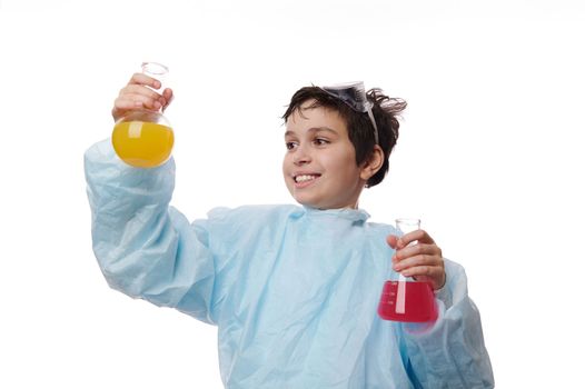 Chemistry lesson. Smart preteen schoolboy, young chemist scientist doing scientific experiment with chemical solutions