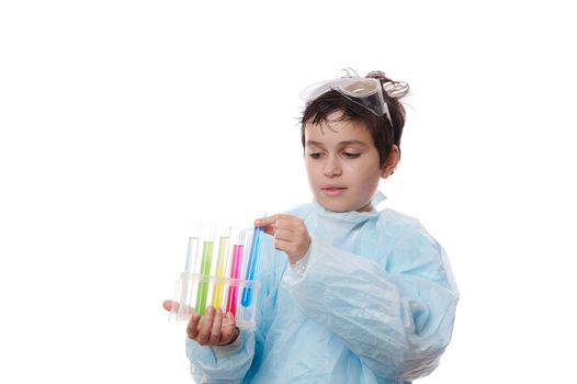 Close-up smart teenage boy, young pupil chemist in lab coat, conducts chemistry experiment isolated on white background