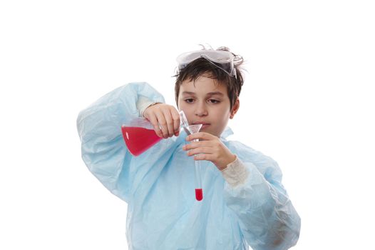Caucasian teenage boy - young chemist scientist in workwear, doing chemical experiments, isolated over white background