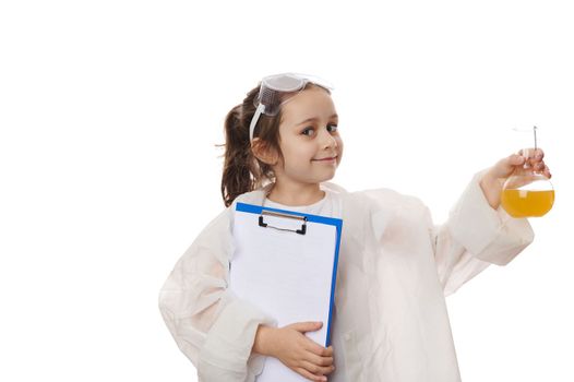 Adorable little girl, inspired young chemist-scientist holding a flask with chemical substance and clipboard, on white