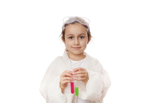 Adorable child girl, little chemist holding test tubes with liquid chemicals, isolated on white background. Copy space