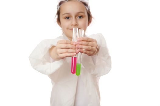 Little child's hands hold out test tubes and show the current chemical reaction in them to the camera. Chemistry lesson