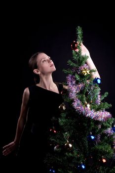 Young woman decorate christmas tree