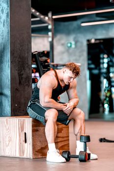 athlete resting in the gym between exercises