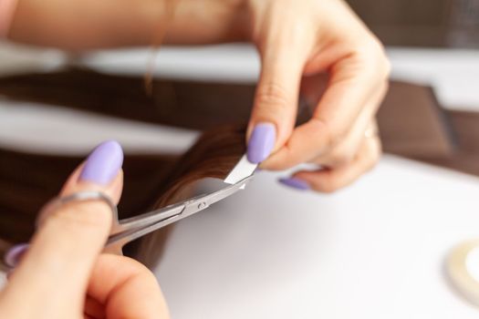 The process of preparing a hair ribbon for extension at home.