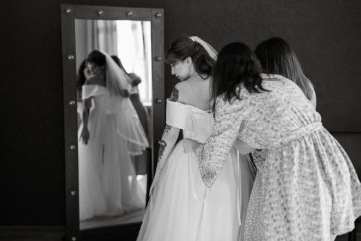 preparations for the bride with the dressing of the wedding dress