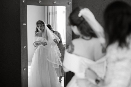 preparations for the bride with the dressing of the wedding dress