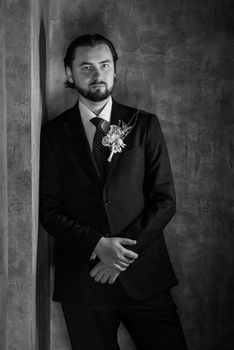 portrait of a male groom in a blue suit in the morning  barbershop