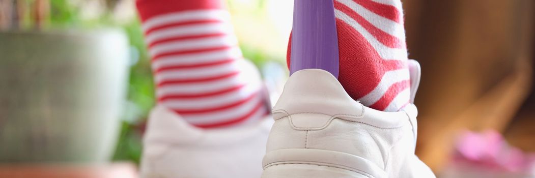 Wear athletic shoes with shoe spoon closeup