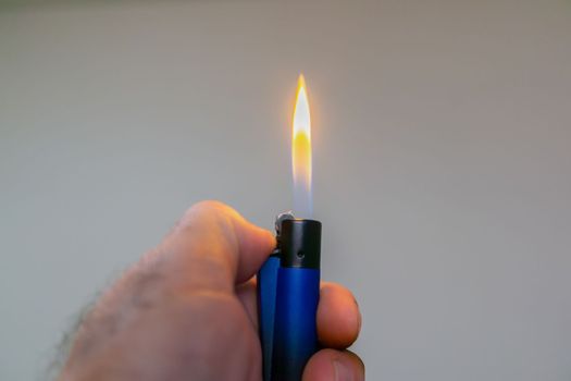 man's hand lighting a lighter
