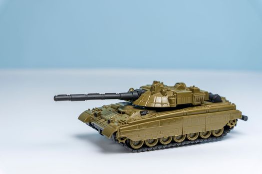 toy military tank rides on the surface on a light background