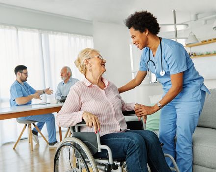 nurse doctor senior care caregiver help assistence wheelchair retirement home nursing elderly woman disabled disability