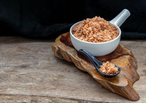 Shrimp paste with Dried shrimps in white Ceramic Bowl on Wooden plank. 