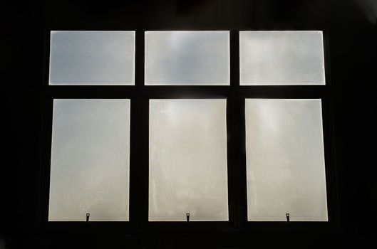 Large glass windows silhouettes frame on black background. 
