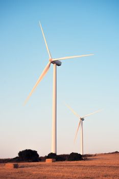 vertical photo of windmills of a wind farm