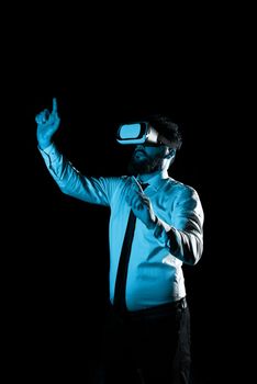 Man Wearing Vr Glasses And Pointing On Important Messages With two Fingers. Businessman Having Virtual Reality Eyeglasses And Showing Crutial Informations.