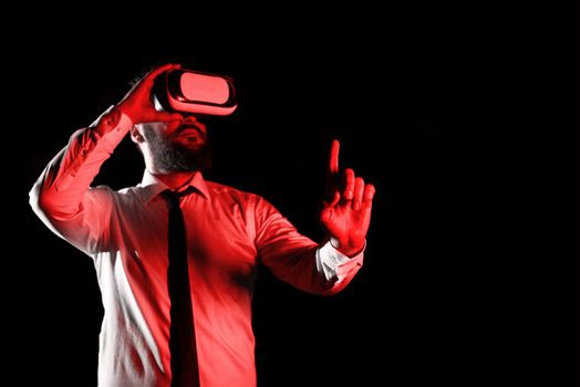 Man Wearing Vr Glasses And Pointing On Important Messages With One Finger. Businessman Having Virtual Reality Eyeglasses And Showing Crutial Informations.