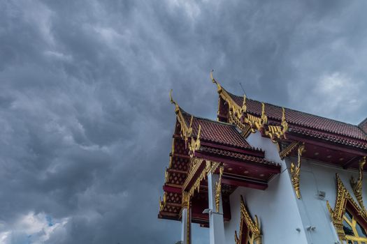 The roof of the Thai temple, along with the gable at the top of the church with a sky backdrop