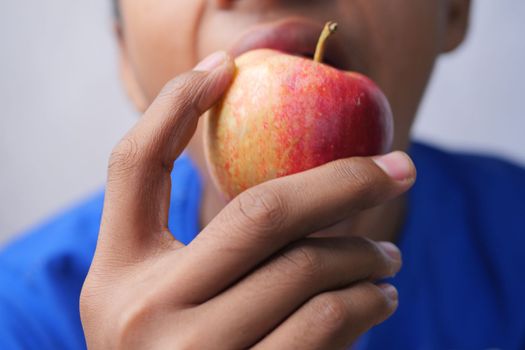 child boy eating apple close up