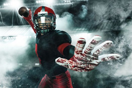 American football player, athlete sportsman in red helmet on grand arena background. Sport and motivation wallpaper.