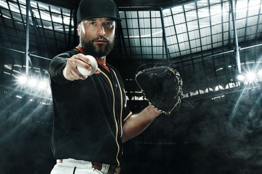 Baseball player with grand arena. Ballplayer on dark background in action.