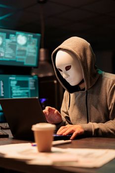 Dangerous masked thief installing virus to hack system