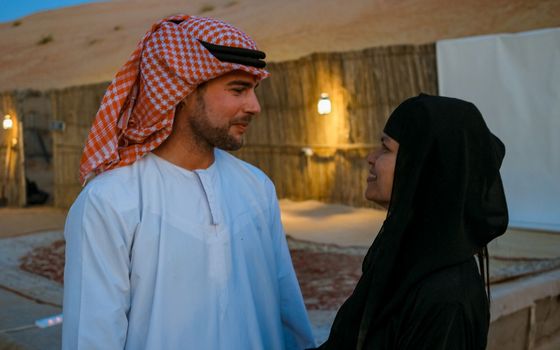 Couple with Arabic clothes during Dubai desert safari at the safari camp, Dubai United Arab Emirates