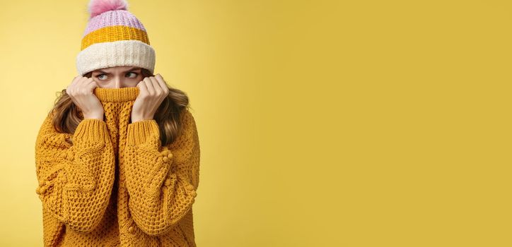 Offended sad whining cute tender young girl hiding face pull sweater nose peek look aside insulted complaining being insulted, standing miserable upset wearing warm winter corduroy hat