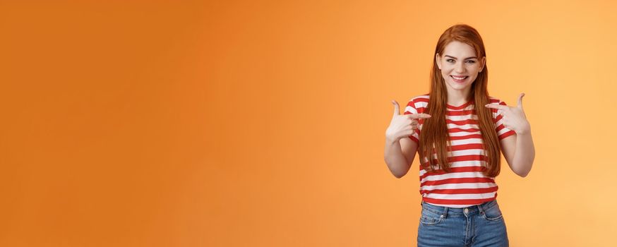 Skilful good-looking redhead motivated girl, pointing herself, indicate fingers chest, bragging joyfully smiling, boastful chat own achievement, stand orange background assertive, wanna participate