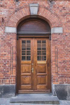 wooden doors with arch in an old brick house in Denmark