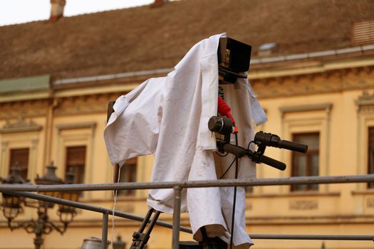 TV camera covered with a cloth waiting for the start of the broadcast