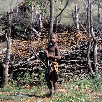 May 15, 2005.Himba village. unidentified Himba boy near the kraal. Epupa Falls, Kaokoland or Kunene Province, Namibia, Africa