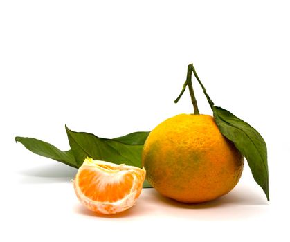Tangerine, tangerine slice and tangerine leaves. 