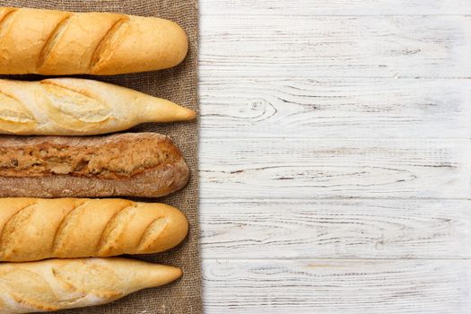 Assortment of fresh French baguettes on a wooden table