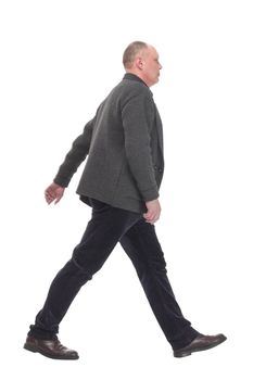 Mature man in casual clothes striding forward.