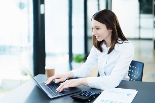 Business planning, portrait of a business woman using a computer to audit financial statements and marketing.