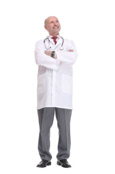 Portrait of a serious mature male doctor in lab coat standing with arms crossed