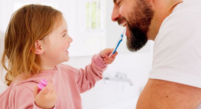 Happy family, dental and brushing teeth with girl and father in bathroom for hygiene, learning and grooming. Love, teeth and oral care by parent with daughter play, laugh and cleaning in their home