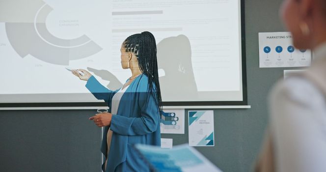 Meeting, presentation and business black woman with data analytics, profit review or growth strategy workshop. Marketing stats, sales charts and speaker in seminar on projector, training an audience.