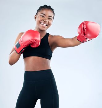 Beauty is confidence, beauty is kindness, beauty is strength. Studio shot of a sporty young woman wearing boxing gloves while posing against a studio background.
