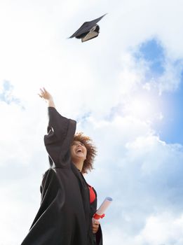 Black woman, graduation and cap in air for celebration, happiness or success with diploma for studying at campus. University student, gen z girl and happy for goal, vision and achievement at academy