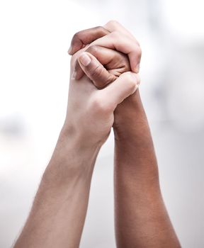Together we build each other up. two protestors joining hands in unity during a protest.