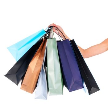 Bags of bargain buys. a young woman carrying shopping bags isolated on white.