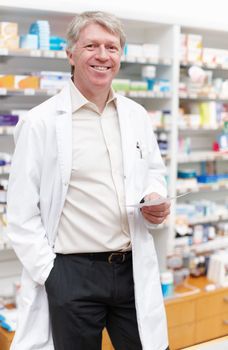 Pharmacist with medical prescription. Portrait of confident pharmacist holding medical prescription in drugstore.