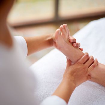 Relaxing foot massage. a woman enjyoing a massage at the day spa.