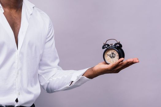 Time Management Concept. Shocked black man holding wall clock, running out of time.