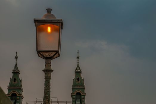 Lamp on the Hammersmith Bridge in the west side of London The first suspension bridge that crossed the River Thames from Hammersmith to Barnes