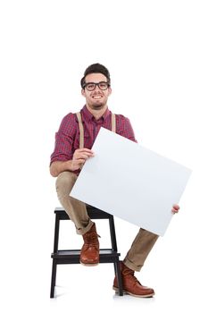 Man, studio portrait and paper board for marketing, branding mockup and vote by white background. Young model, isolated and sitting with mock up poster, holding billboard and space for advertising