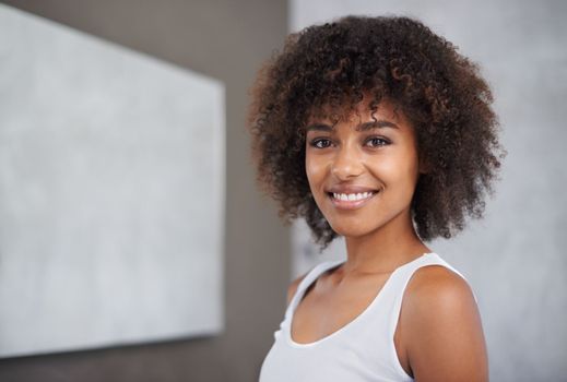 Going through her morning routine with a smile. Portrait of an attractive young woman standing in her home.
