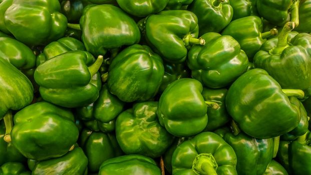 a tray of green pepper (green capsicum) found in a market 